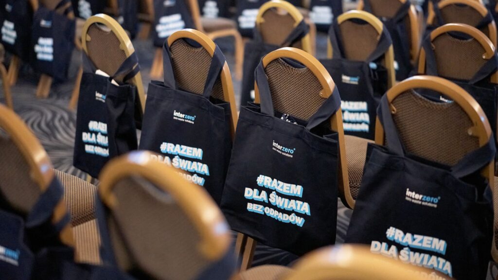 bags from an environmental conference hung on chairs in the hall